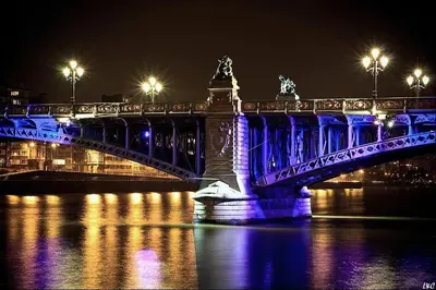 a bridge that is lit up blue at night at Studio des jardins suspendus in Liège
