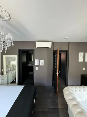 a bedroom with a bed and a mirror at L'écrin des Vennes - Liège centre in Liège