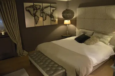 a bedroom with a large bed with a white bedspread at B&B Serenity in Pelt