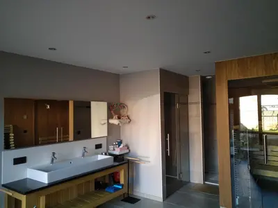 a bathroom with a tub and a sink and a shower at Vakantiewoning Mierzicht - privé wellness - Haspengouw 6p in Boekhout
