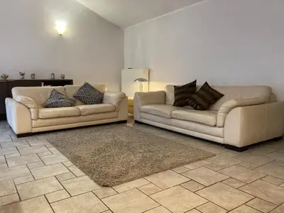 a living room with two couches and a rug at Thier à Liege - hauts-sart in Liège
