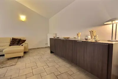 a hotel room with a reception desk and a couch at Thier à Liege - hauts-sart in Liège