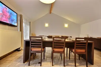 a dining room with a large table and chairs at Thier à Liege - hauts-sart in Liège