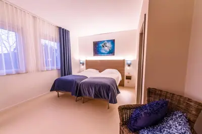 a hospital room with two beds and a couch at ManavaHotel in Herstal