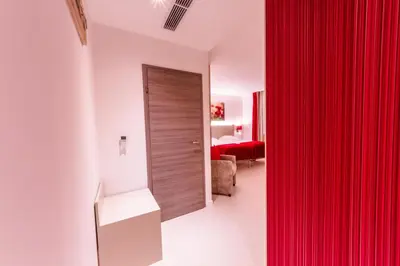 a red curtain in a room with a bedroom at ManavaHotel in Herstal