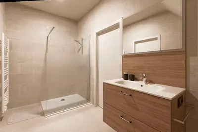 a bathroom with a sink and a shower at Wijndomein Zwaeneberg in Voeren