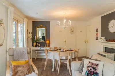 a living room with a table and a dining room at Chalet 2Relax in Zutendaal