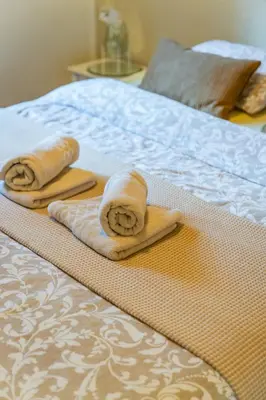 a pair of towels sitting on top of a bed at Chalet 2Relax in Zutendaal