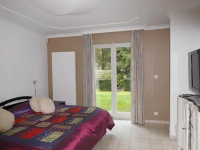a bedroom with a bed and a window at Suite Horatio in Heusden - Zolder