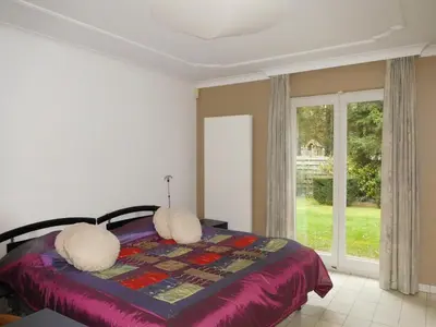 a bedroom with a bed and a window at Suite Horatio in Heusden - Zolder