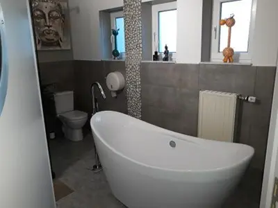 a bathroom with a white tub and a toilet at Villa Marco 176 in Cerexhe-Heuseux