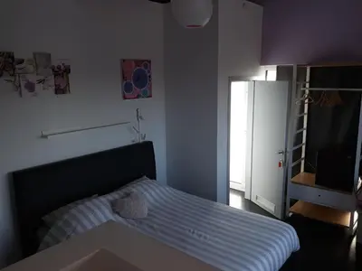 a small bedroom with a bed and a refrigerator at Villa Marco 176 in Cerexhe-Heuseux