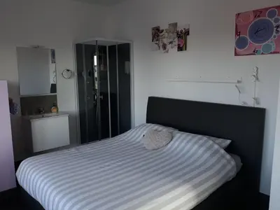 a bedroom with a bed with a black and white comforter at Villa Marco 176 in Cerexhe-Heuseux