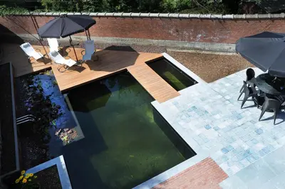 an overhead view of a swimming pool with an umbrella at Charmehotel Villa Saporis in Hasselt