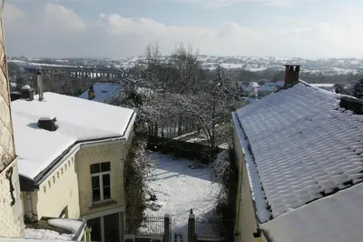 a snow covered roof of a house with snow covered roofs at Aux Herbes Folles in Herve