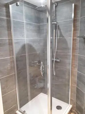 a shower with a glass door in a bathroom at Chez Vivi in Ans