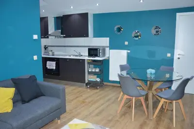 a living room with a couch and a glass table at Chez Vivi in Ans