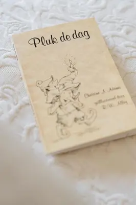 a book with a drawing of a dog on a bed at B&B Hof van Vervoering in Voeren