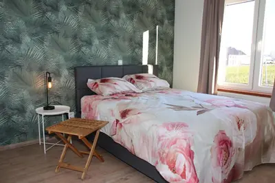 a bedroom with a bed and a table in it at Juwel Fruithof in Zepperen