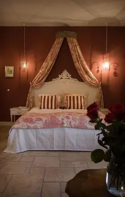 a bedroom with a large bed with a canopy at Auberge 's Gravenhof in Voeren