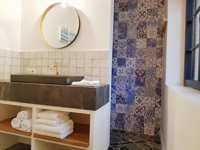 a bathroom with a sink and a mirror at Vakantiehuis ABEL in Dilsen-Stokkem