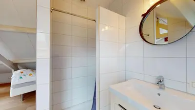 a bathroom with a sink and a mirror at SintPieter17 Lo-Ghis vakantiewoning in Voeren