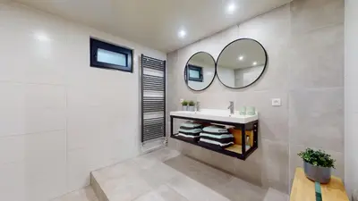 a bathroom with a sink and a mirror at SintPieter17 Lo-Ghis vakantiewoning in Voeren