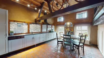 a kitchen with a table and chairs in a room at SintPieter17 Lo-Ghis vakantiewoning in Voeren