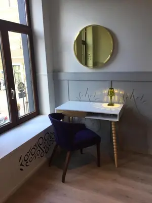 a bathroom with a sink and a mirror and a chair at Domus Basil in Tongeren