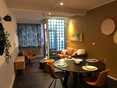 a living room with a table and a couch at Domus Basil in Tongeren