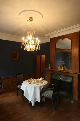a dining room with a table and a chandelier at Het Domherenhuis B&B, Restaurant Calice in Heusden - Zolder