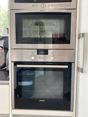 a stainless steel oven with its door open in a kitchen at Joff in Budingen