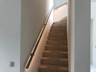 a staircase in a house with a metal rail at Joff in Budingen