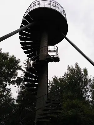 a spiral staircase leading up to a water tower at Vakantiewoning Bij de Jep in Bilzen