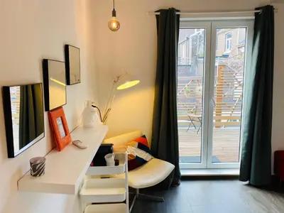 a room with a desk with a chair and a window at L’atelier St Remacle in Liège