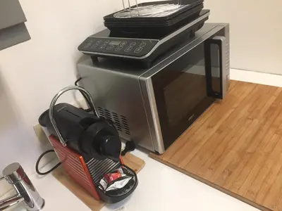 a microwave oven sitting on top of a counter at L’atelier St Remacle in Liège