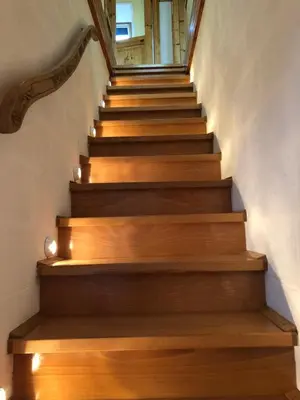 a staircase with wooden treads in a house at Landhaus Sylvia in Eupen, Terrasse , Garten & Nähe zum Hohen Venn in Eupen