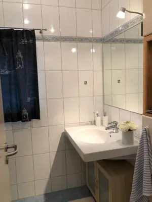 a bathroom with a sink and a mirror at Landhaus Sylvia in Eupen, Terrasse , Garten & Nähe zum Hohen Venn in Eupen