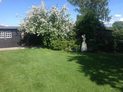 a yard with a statue in the grass at Landhaus Sylvia in Eupen, Terrasse , Garten & Nähe zum Hohen Venn in Eupen