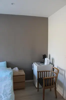 a bedroom with a bed and a table and a chair at Logie Rotem in Dilsen-Stokkem