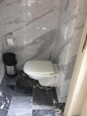 a bathroom with a white toilet in a room at B&B Don Genaro in Dilsen-Stokkem