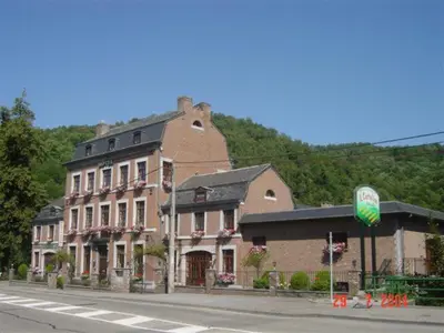 a large brick building on the side of a street at Hotel IL Castellino in Chaudfontaine