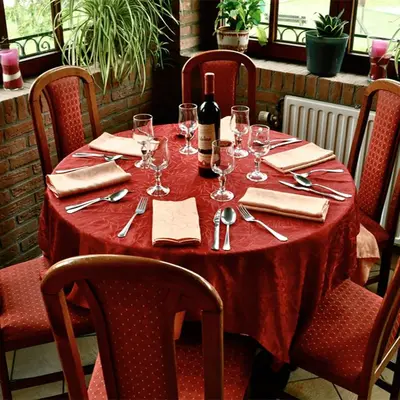 a table with wine glasses and a bottle of wine at Hotel IL Castellino in Chaudfontaine