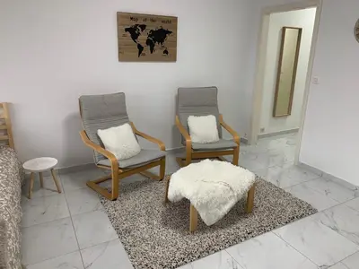 two chairs and a ottoman in a living room at Le Cocon d'Avroy in Liège