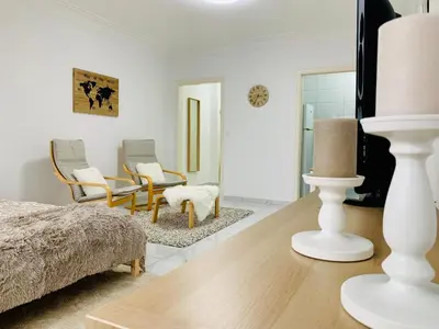 a bedroom with a bed and chairs in a room at Le Cocon d'Avroy in Liège