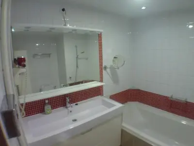 a bathroom with a tub and a sink and a mirror at Liège centre 13 Quai Godefroid Kurth POUR 2 PERS à 25 min gare Guillemins in Liège