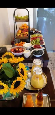 a buffet of food with sunflowers on a table at Belrom Hotel in Sint-Truiden