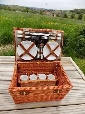 a wicker basket with dishes in it on a table at La Pause in Plombières