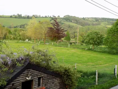 a building with flowers on top of it in a field at La Pause in Plombières