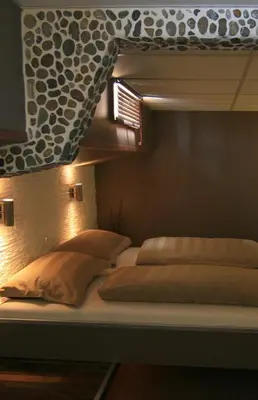 a bed with two pillows on top of it at Botel Ophoven in Kinrooi